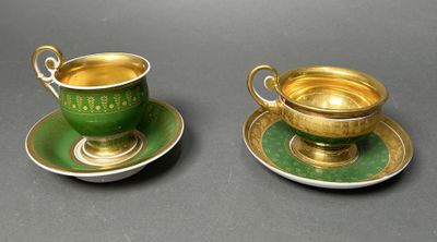 two green and gold cups and saucers on a gray surface