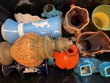many different vases and bowls in a bin