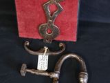a metal key and a red box on a black table
