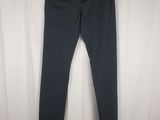 a pair of dark blue pants hanging on a hanger