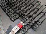 a lot of black metal racks on a table