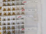 a lot of different types of metal studs in a box