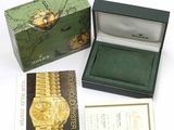 a box with a watch inside of it and a business card in it