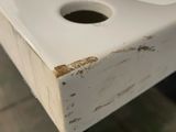 a white sink sitting on top of a wooden table