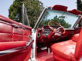 the interior of a classic car with red leather seats and a steering wheel