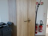a desk with a printer and a cabinet in the room
