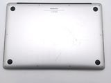 the back of a laptop with a cracked screen on a white surface