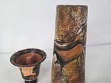 two vases sitting next to each other on a table