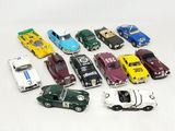 a lot of toy cars that are on a white surface