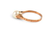 an image of a gold ring with a pearl in the middle