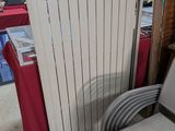 a chair that is next to a radiator in a room