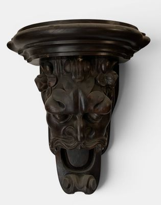 a close up of a lion head on a wall mounted on a white wall