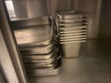 many metal pans lined up in the kitchen