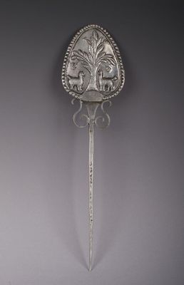 an antique silver spoon with a decorative design on the handle