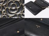a close up of a black purse with a chain around it