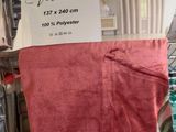a red towel hanging on a rack in a store