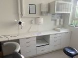 an image of a dentist ' s office with a desk and chair