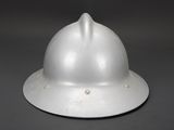 a close up of a silver helmet on a black background