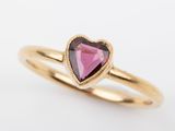 a gold ring with a heart shaped pink tourmaline stone