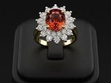 gros plan d'une bague avec une pierre rouge entourée de diamants blancs