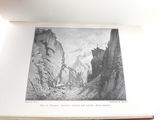 an open book with a picture of a mountain scene on it