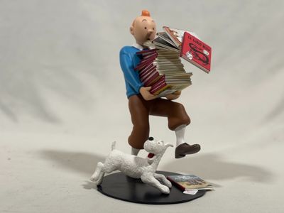 figurine of a man with a stack of books and a dog