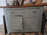 a small kitchen with a wooden counter top and a refrigerator