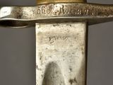 a close up of a knife with a gold handle