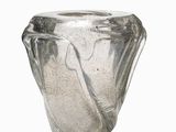 a glass vase that is sitting on a white surface