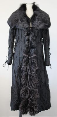 a black coat with a fur collar on a mannequin stand