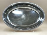 an image of a silver plate on a stand on a table