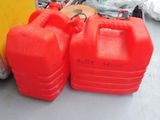 two red plastic containers sitting next to each other on the floor