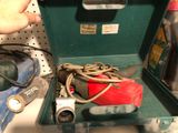 a green case with a bunch of tools inside of it