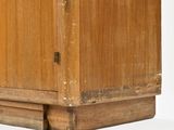 a wooden cabinet with a door on the top of it
