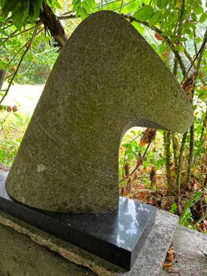 a stone sculpture of a horse head on top of a stone block