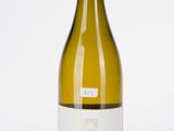 the bottle of white wine is sitting on the table