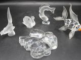 a lot of glass figurines that are sitting on a table