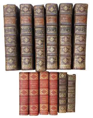 a group of books sitting on top of each other on a white surface