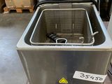 a close up of a fryer sitting on top of a wooden table