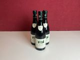 two bottles of wine sitting on a table
