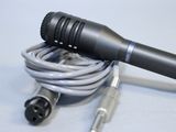 a microphone with a cord attached to it on a table