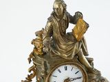 a statue of a man sitting on top of a clock