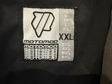 a close up of a black jacket with a white and black logo on it