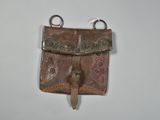 brown leather purse hanging on a wall on a white surface