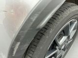 a close up view of a car ' s tire with a lot of scratches on it
