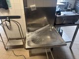 a stainless steel sink in the middle of a kitchen