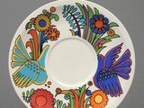a stack of plates with a bird design on them