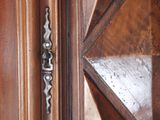 a close up of a door handle on a wooden door