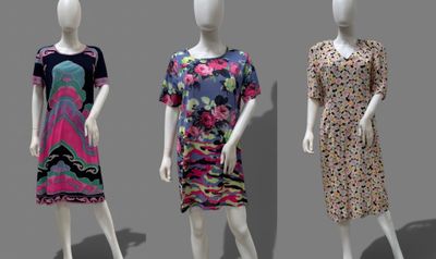 three mannequins dressed in different styles of clothing on display