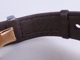 a close up of a watch that is on a white surface